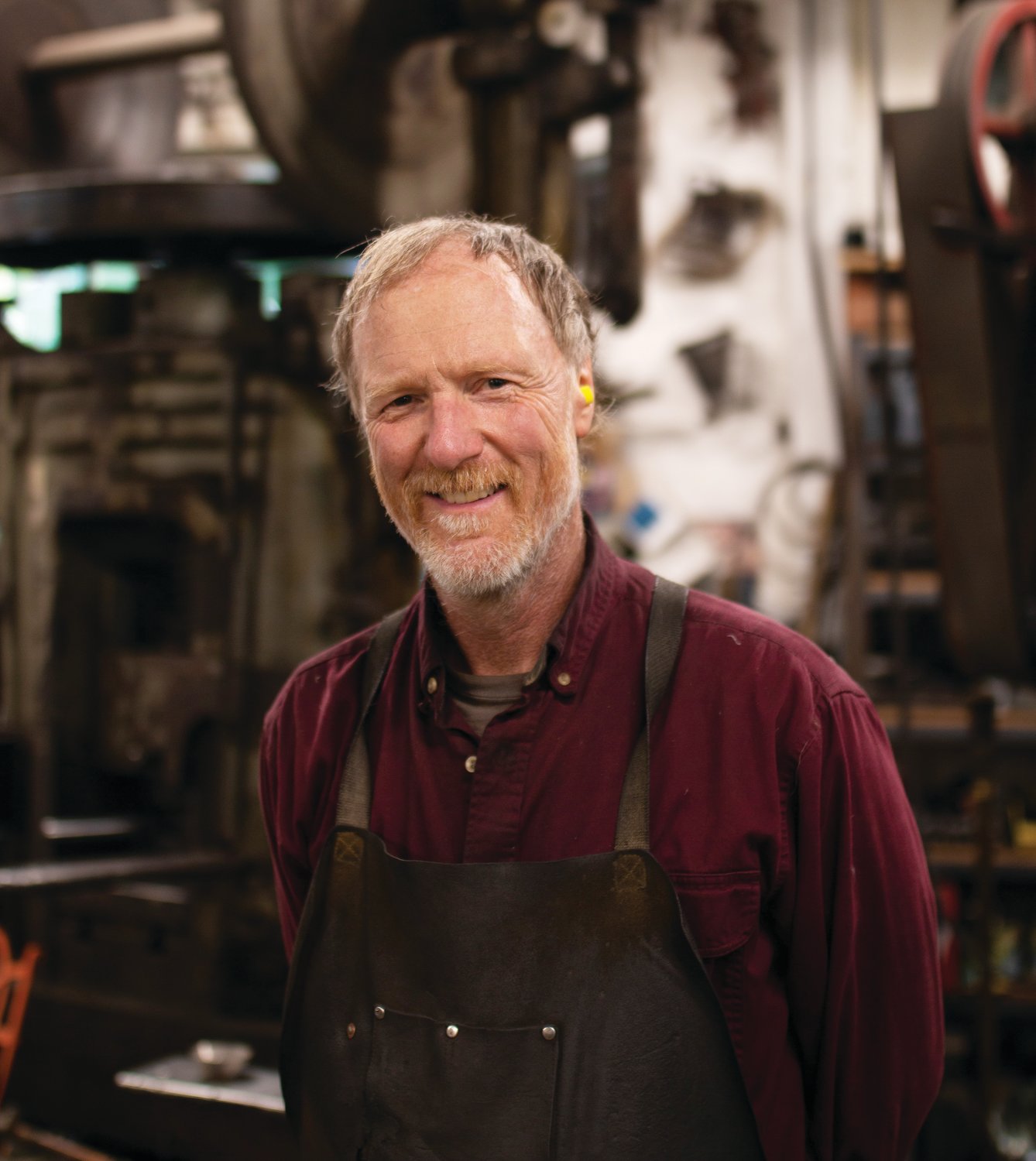 Jim Moore pauses work for a portrait in his metal shop.